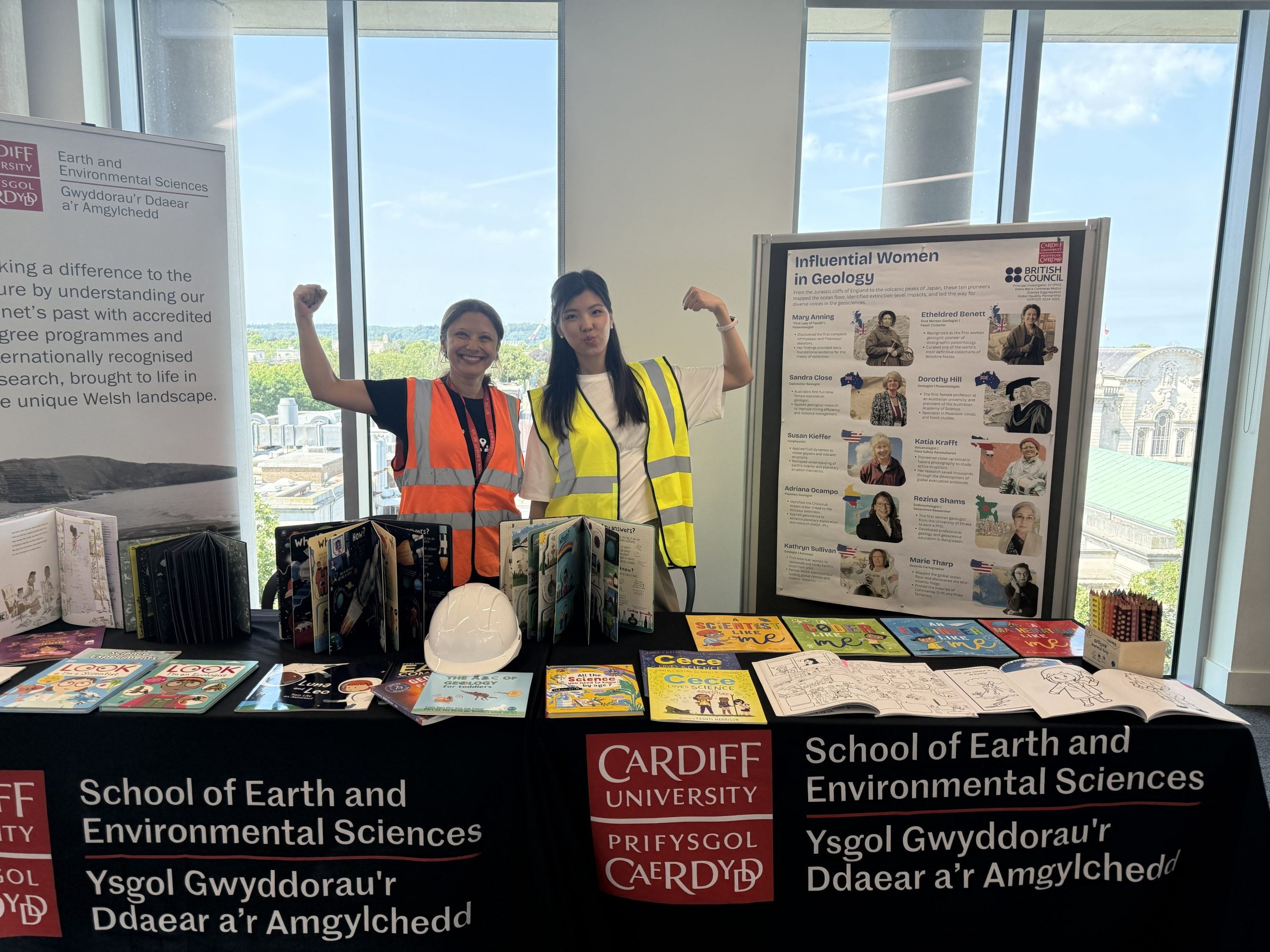 Figure 1. The Research Assistant, Ms Zhaniya Sagyndykova and the Project Lead, Dr (PhD) Diana Contreras, wearing Hi-Viz and displaying STEM books promoting gender equality in STEM among children.